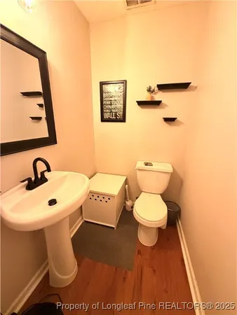 a bathroom with a toilet a sink and a mirror