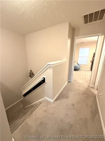a view of a hallway with staircase