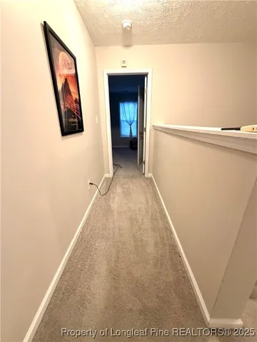 a view of a hallway with wooden floor and a large window