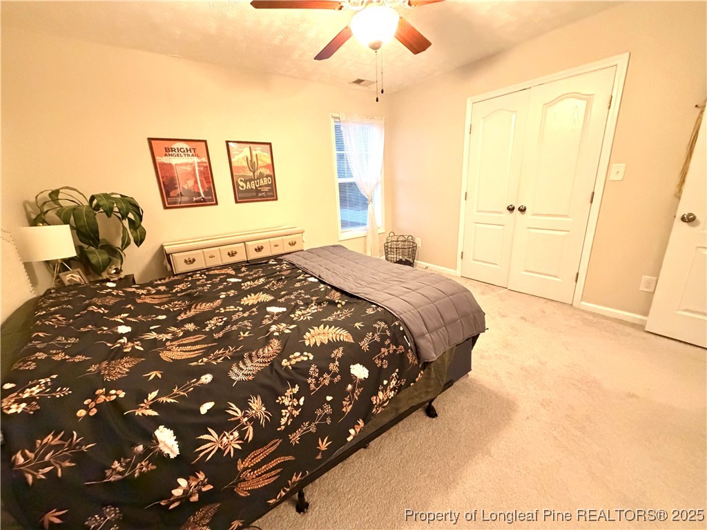 210 Roanoke Drive Raeford, NC 28376 - Photo 17 of 29 a bed sitting in a spacious bedroom next to a window