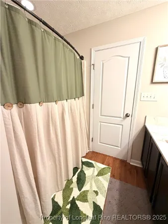 a bathroom with a sink and a shower curtain