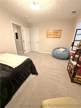 a bedroom with a bed and a mirror