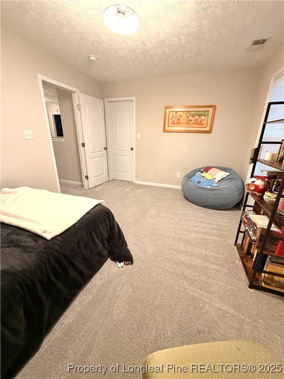 210 Roanoke Drive Raeford, NC 28376 - Photo 25 of 29 a bedroom with a bed and a mirror