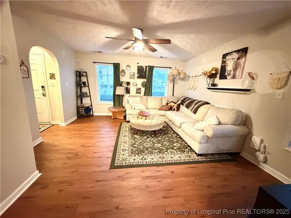a living room with furniture and a chandelier