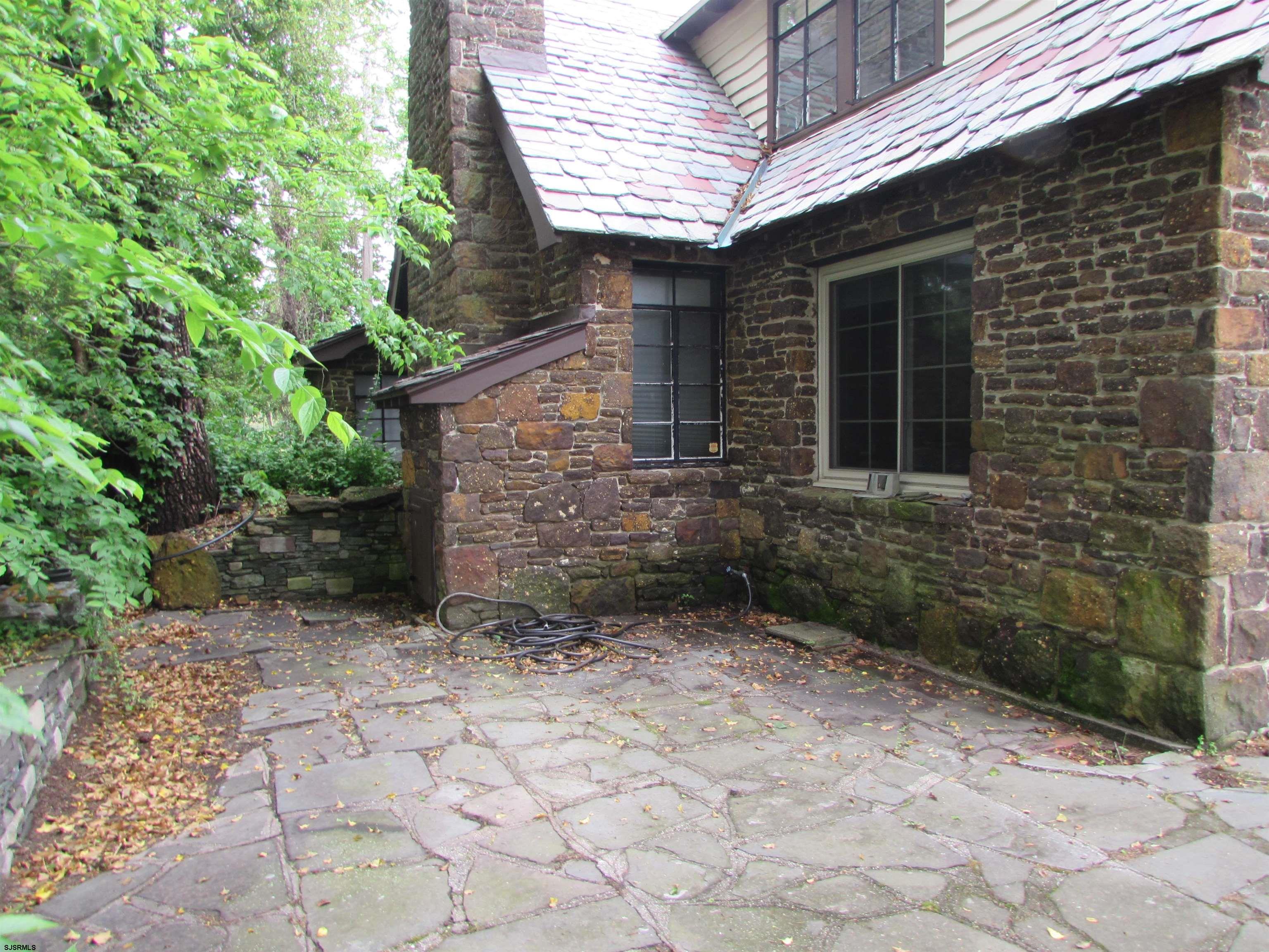 744 Shore Road Linwood, NJ 08221 - Photo 5 of 43 a view of a backyard with plants and brick wall