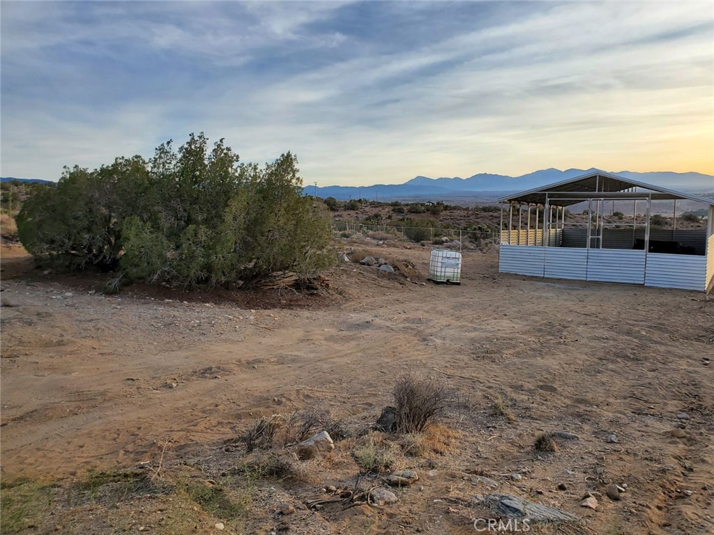7380 High Hill Road Apple Valley, CA 92308 - Photo 2 of 3 a view of a dry yard with mountain