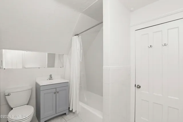 a bathroom with a toilet a sink and shower