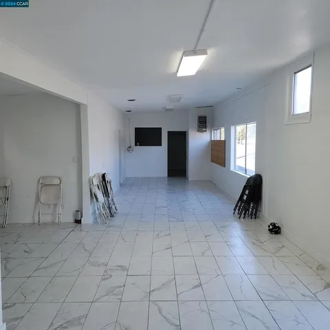 a room with granite countertop lots of white and green walls