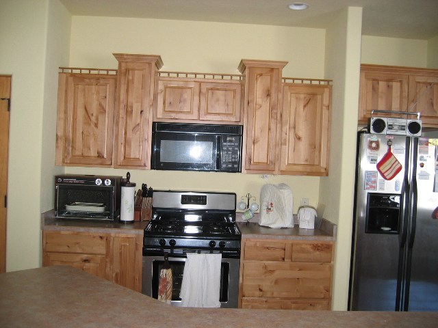 407 Kismet Street Ridgway, CO 81432 - Photo 2 of 6 a kitchen with stainless steel appliances granite countertop a refrigerator and a stove top oven