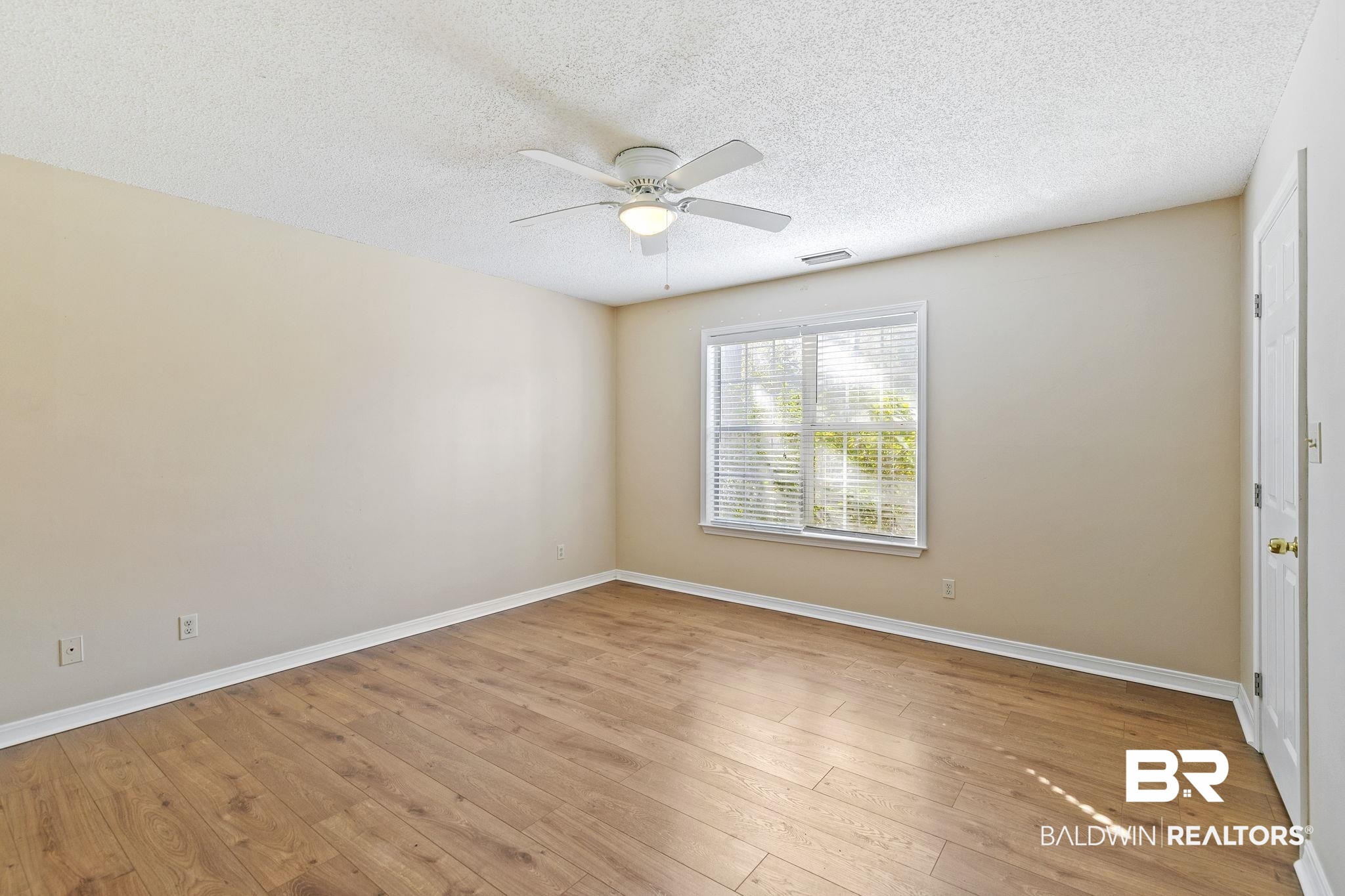 359 Ridgewood Drive Daphne, AL 36526 - Photo 29 of 73 Downstairs Primary Bedroom with LVP Flooring and ceiling fan