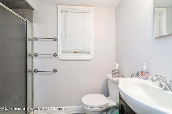 a white toilet sitting next to a bathroom sink