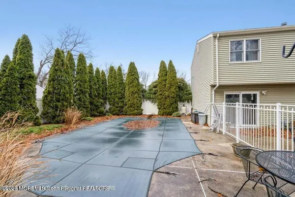 a view of a patio with table and chairs and potted plants