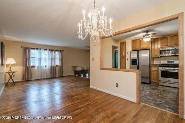 a view of a room with wooden floor and windows