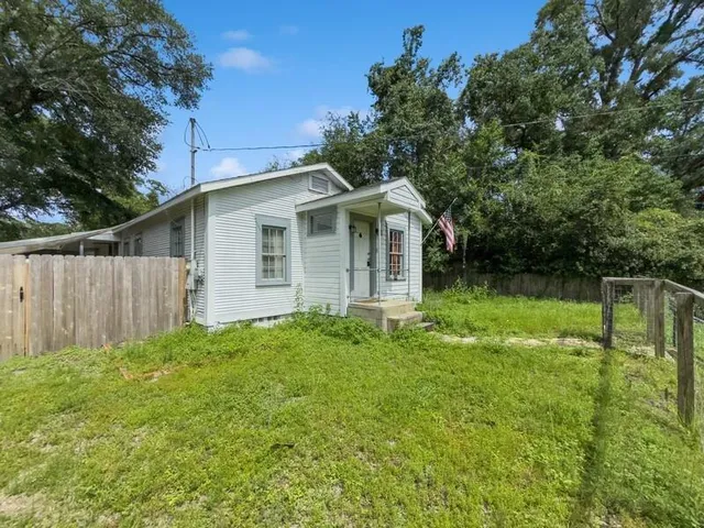 a front view of house with yard and green space