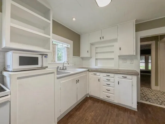 a kitchen with a stove oven and sink