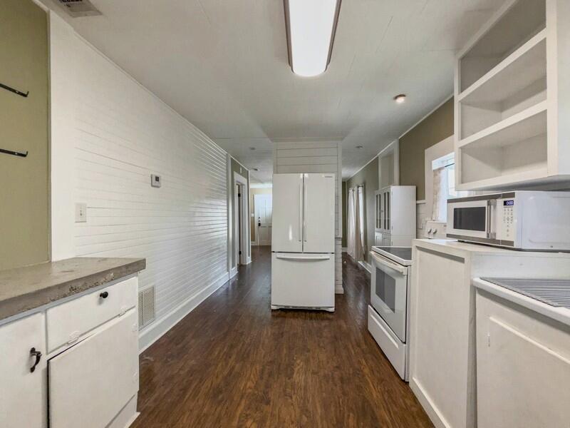 383 North Booker Street Crestview, FL 32536 - Photo 16 of 36 a kitchen with stainless steel appliances a refrigerator and a stove top oven