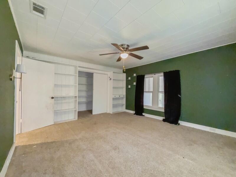 383 North Booker Street Crestview, FL 32536 - Photo 22 of 36 an empty room with closet and a ceiling fan