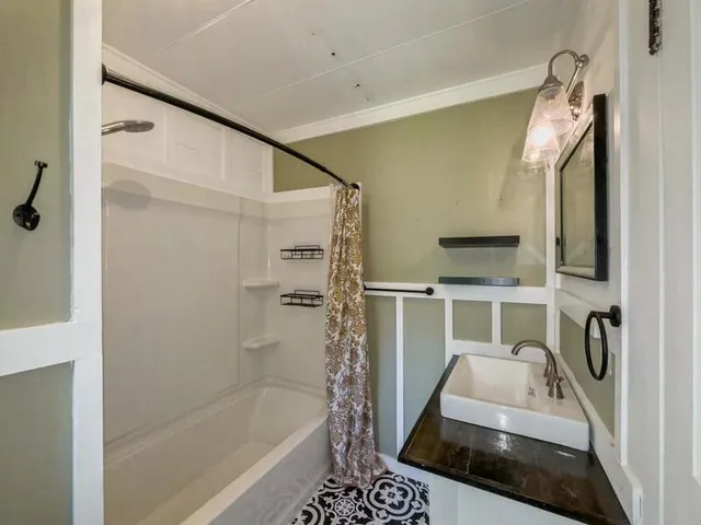 a bathroom with a toilet sink and shower