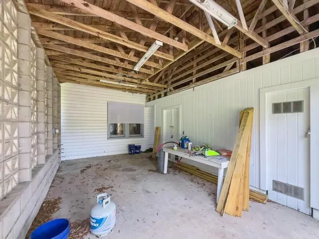 a backyard of a house with table and chairs