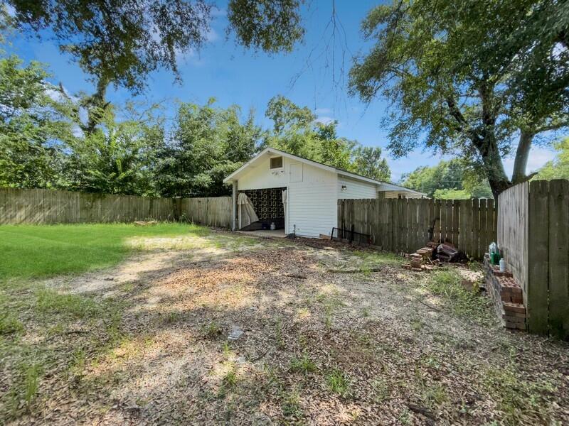 383 North Booker Street Crestview, FL 32536 - Photo 33 of 36 a backyard of a house with table and chairs