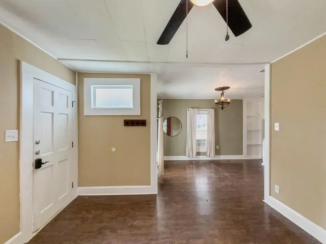 a view of an empty room and wooden floor