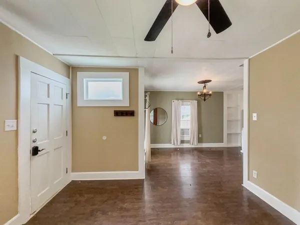 a view of an empty room and wooden floor