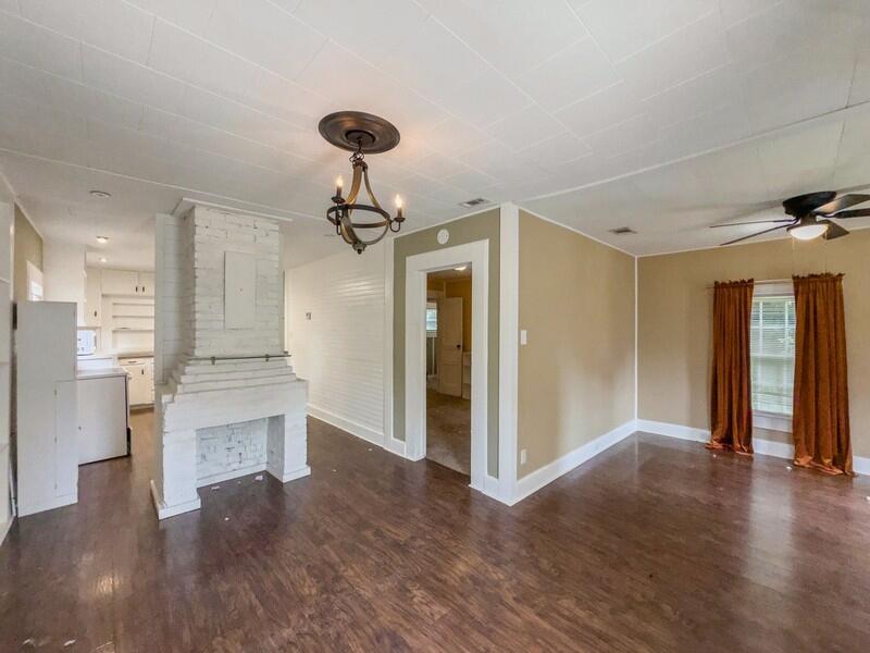 383 North Booker Street Crestview, FL 32536 - Photo 6 of 36 a view of an empty room with a window and wooden floor