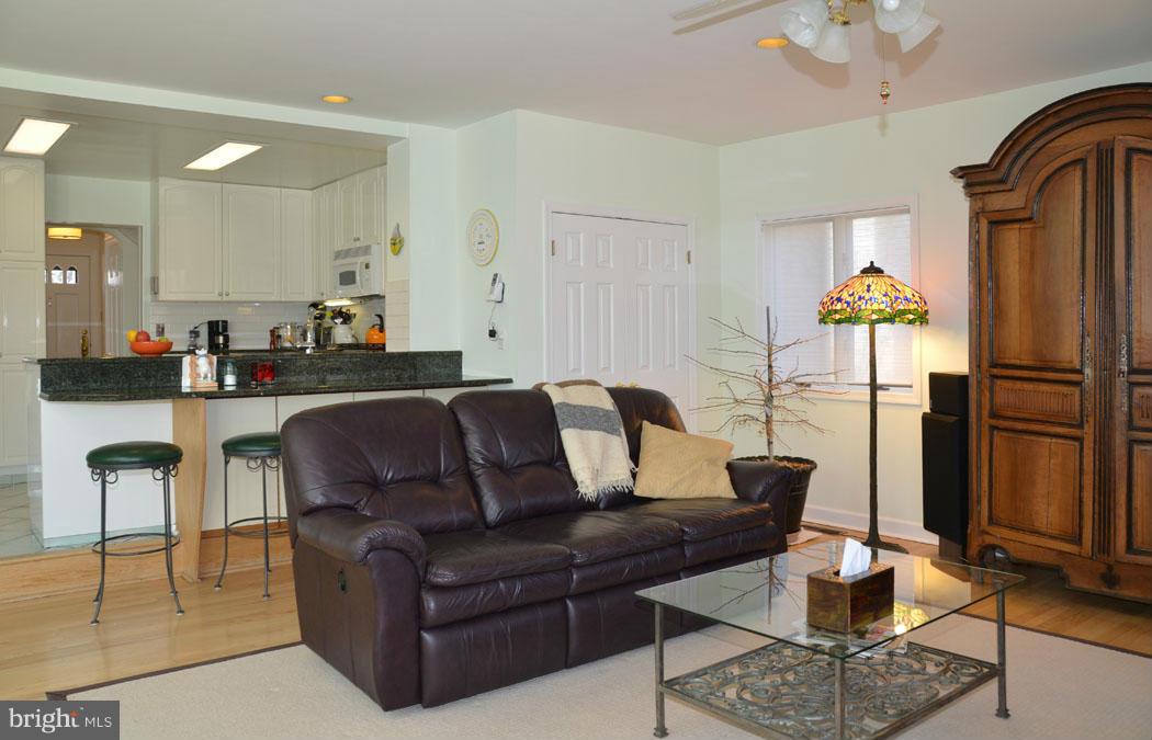5603 Ridgefield Road Bethesda, MD 20816 - Photo 13 of 30 a living room with furniture a rug and a chandelier
