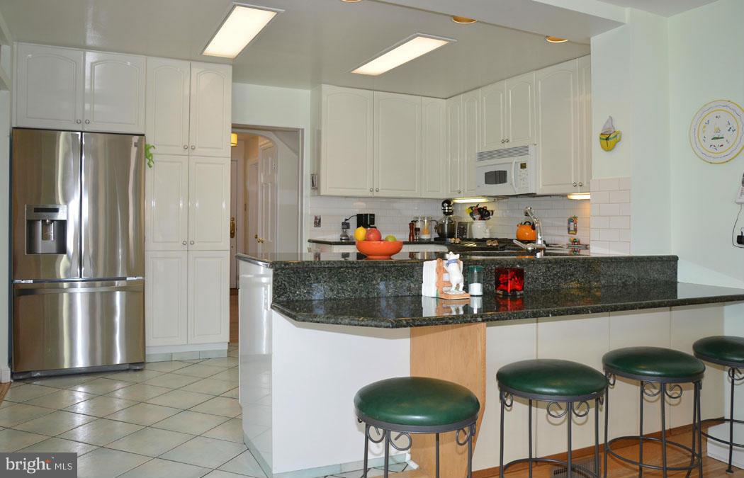 5603 Ridgefield Road Bethesda, MD 20816 - Photo 17 of 30 a kitchen with stainless steel appliances granite countertop a refrigerator and a stove top oven