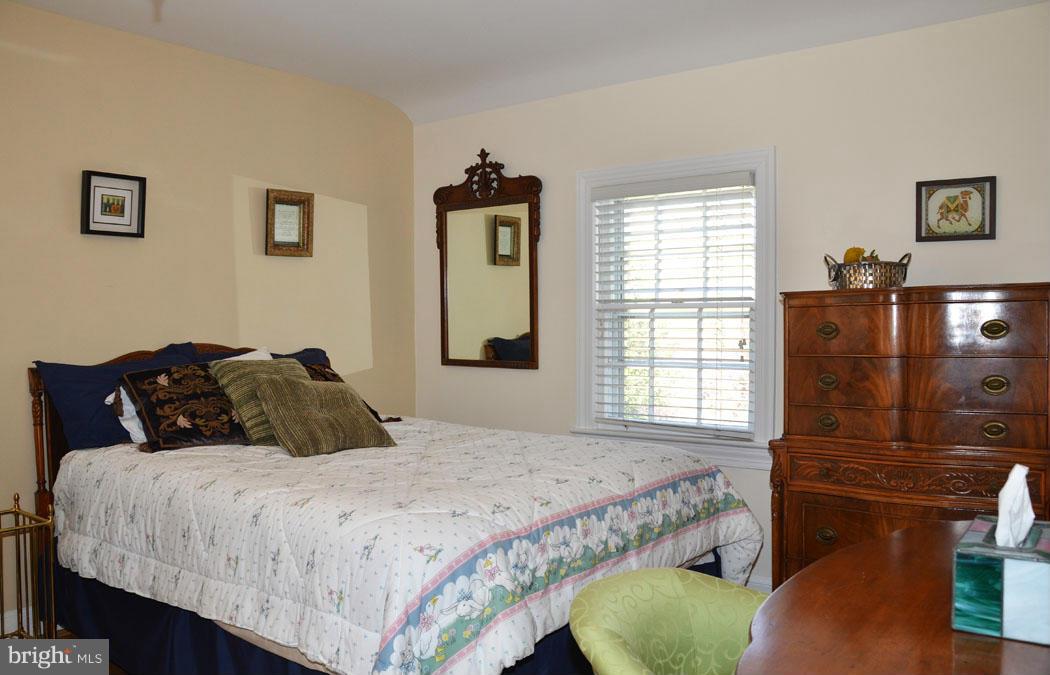 5603 Ridgefield Road Bethesda, MD 20816 - Photo 21 of 30 a bedroom with a bed mirror and window