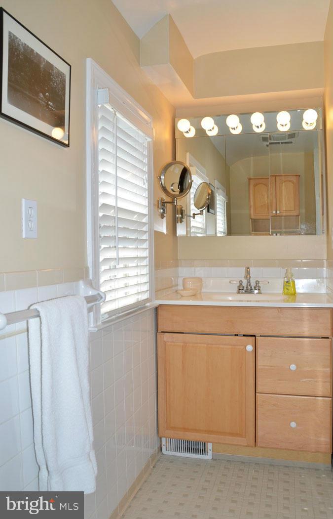 5603 Ridgefield Road Bethesda, MD 20816 - Photo 22 of 30 a bathroom with a sink vanity and a mirror