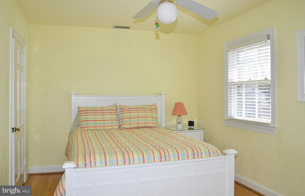5603 Ridgefield Road Bethesda, MD 20816 - Photo 24 of 30 a bedroom with a bed and wooden floor