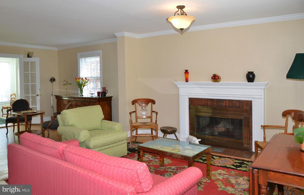 5603 Ridgefield Road Bethesda, MD 20816 - Photo 4 of 30 a living room with furniture a dining table and a fireplace