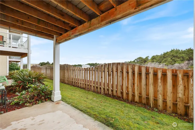 a view of a backyard with wooden fence