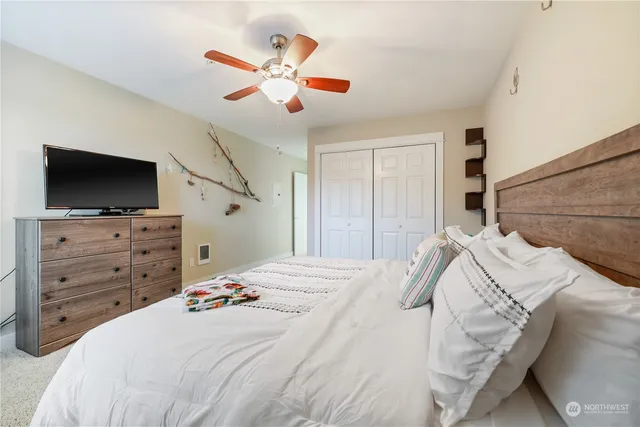 a bedroom with a bed and a flat screen tv