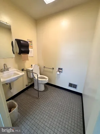 a bathroom with a sink toilet and mirror