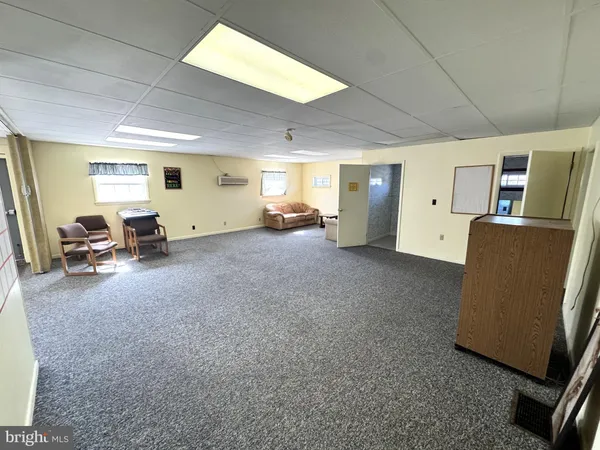 a view of a livingroom with furniture and a flat screen tv