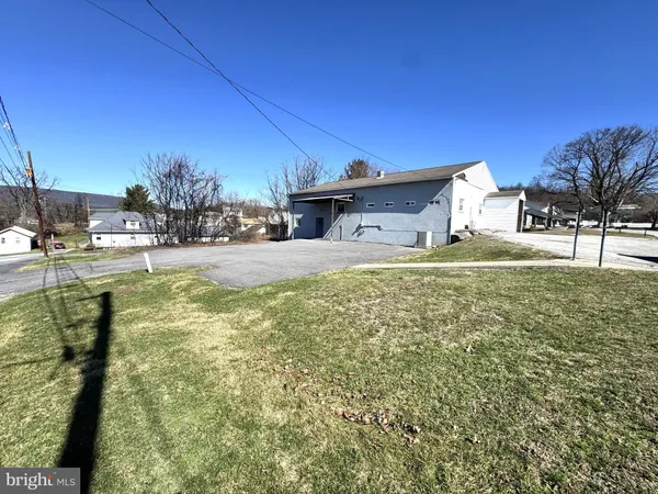 a swimming pool with outdoor seating and yard