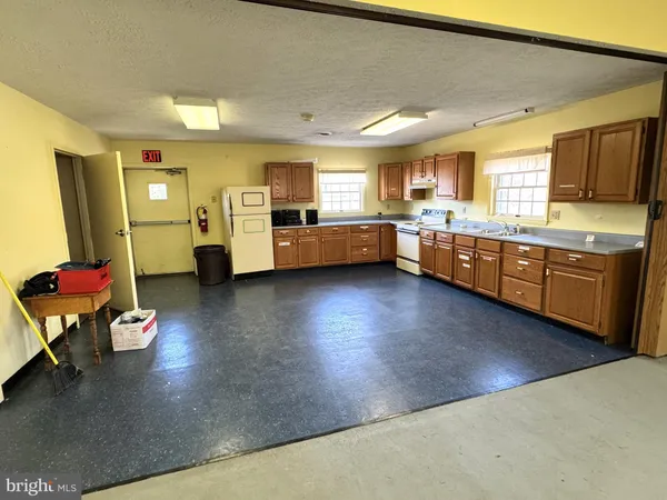 a kitchen with sink refrigerator and cabinets