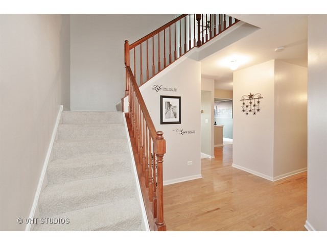 1069 Horizon Ridge Lake In The Hills, IL 60156 - Photo 2 of 10 a view of a hallway with wooden floor and staircase