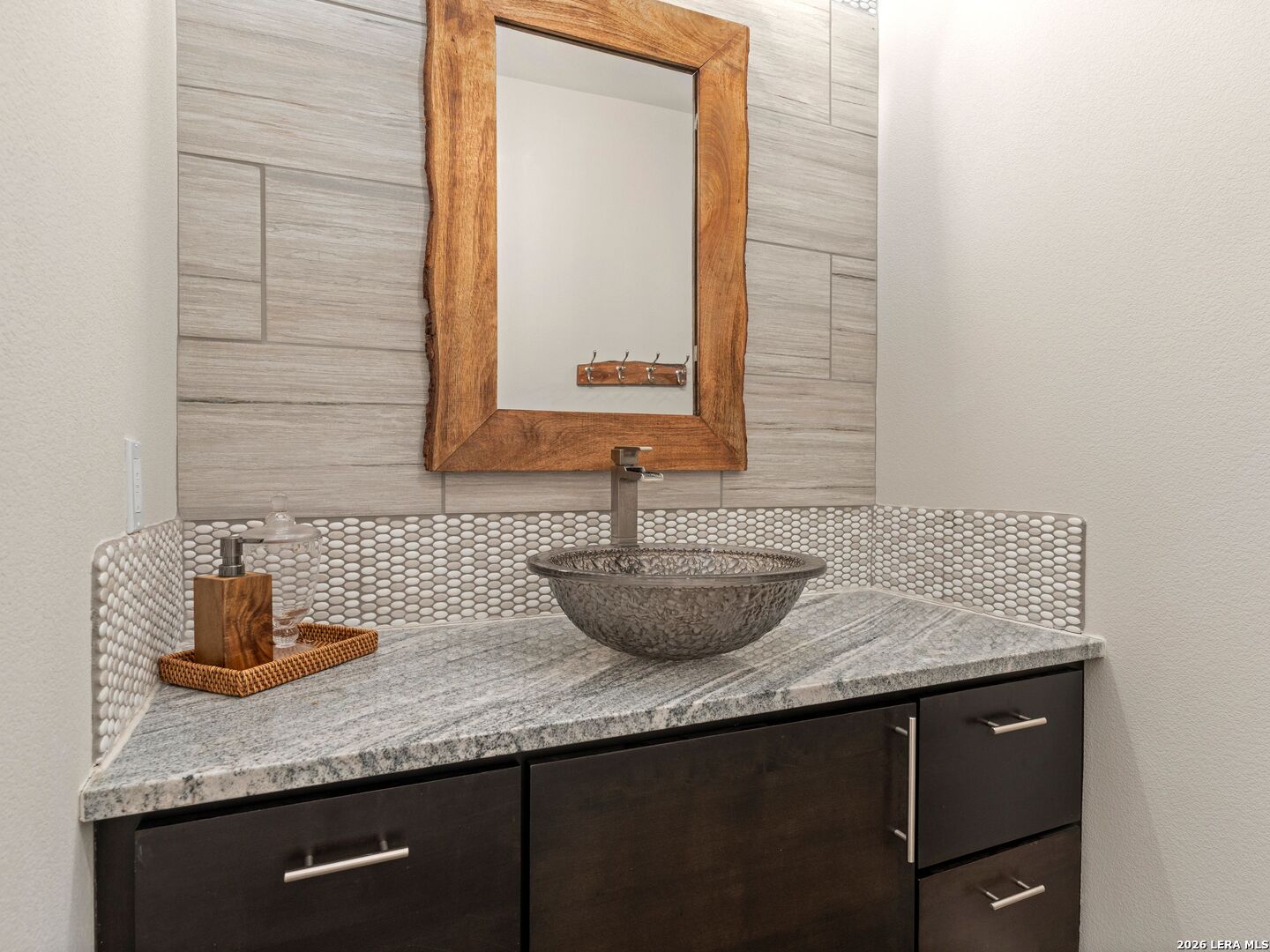 1146 Victoria Avenue Spring Branch, TX 78070 - Photo 40 of 89 a bathroom with a granite countertop sink and a mirror