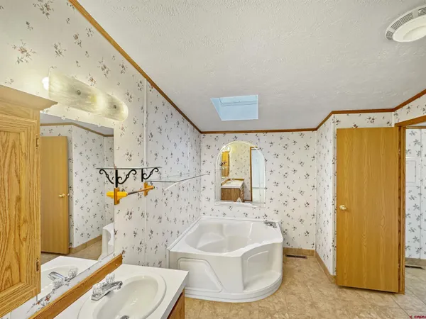 an empty room with a mirror and a ceiling fan