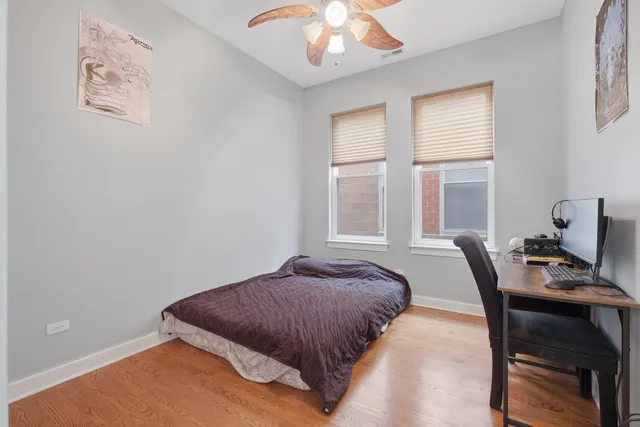 a bedroom with a bed and a painting on the wall