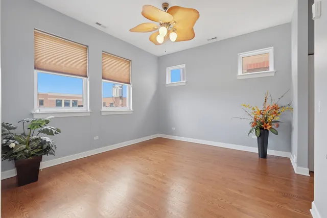 a view of an empty room and window with wooden floor