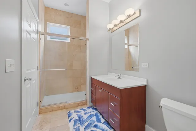 a bathroom with a sink a toilet and a mirror