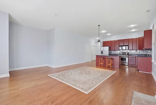 a kitchen with stainless steel appliances granite countertop a sink dishwasher a stove with wooden cabinets