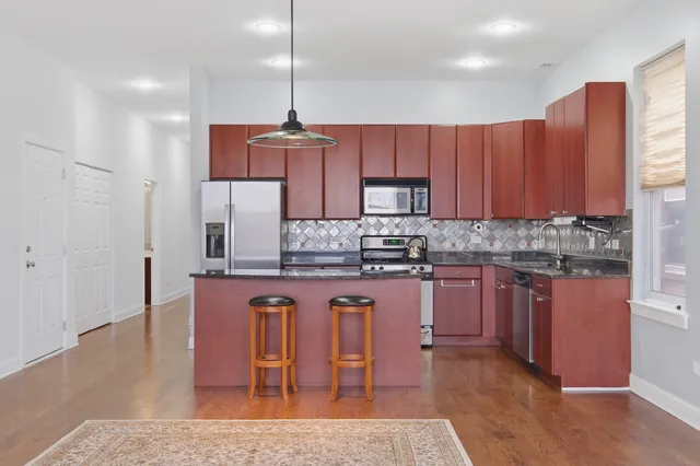 a view of an empty room with a window and fire place