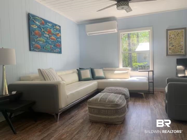 42090 Bayou Road Bay Minette, AL 36507 - Photo 3 of 13 Living area featuring dark wood-style floors, a wall mounted mini split, and ceiling fan