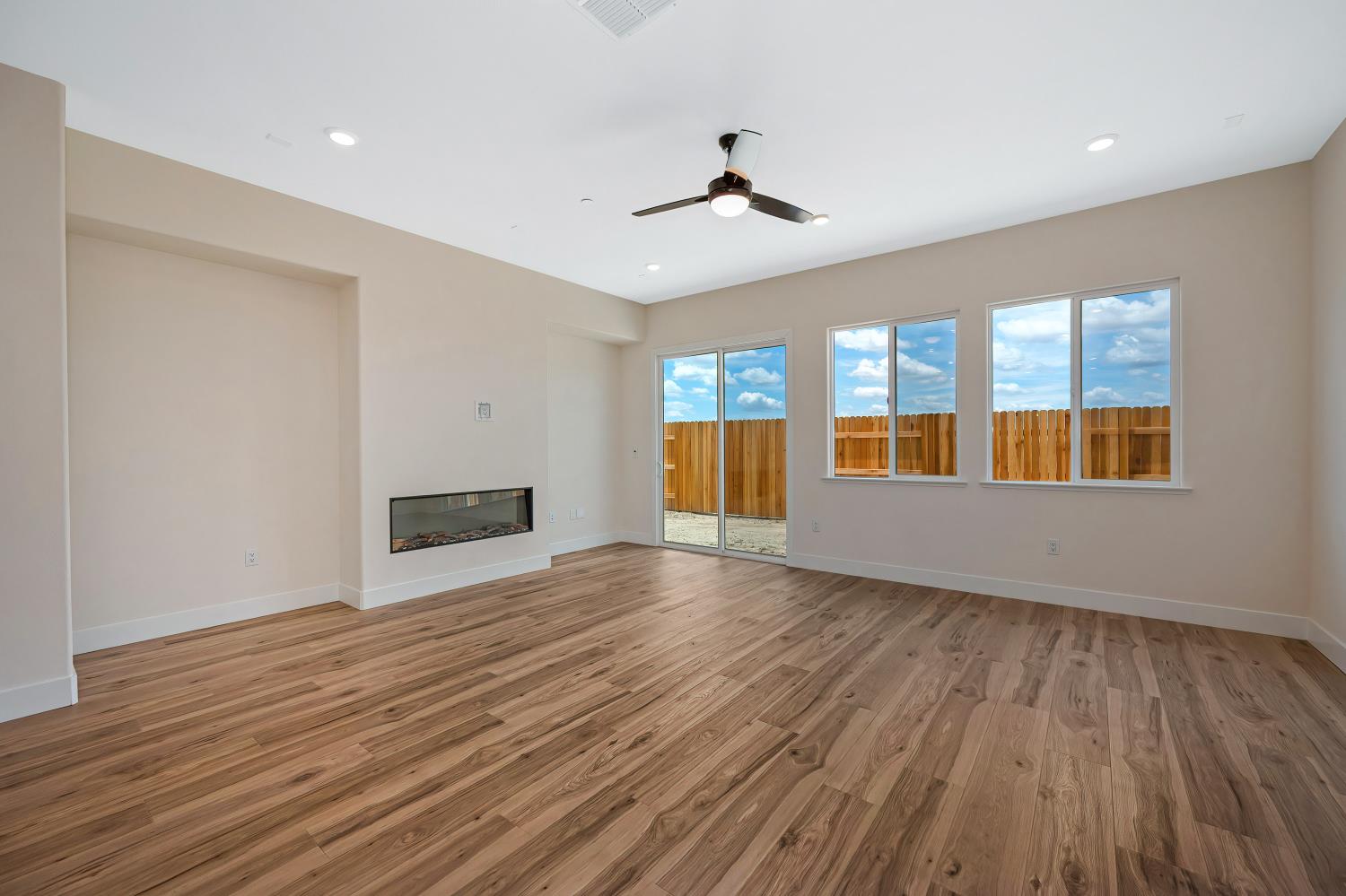 3922 Buxus Road Rocklin, CA 95765 - Photo 5 of 11 a view of an empty room with window and wooden floor