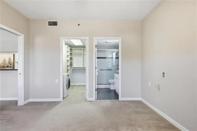 a bathroom with a granite countertop sink a toilet and a shower